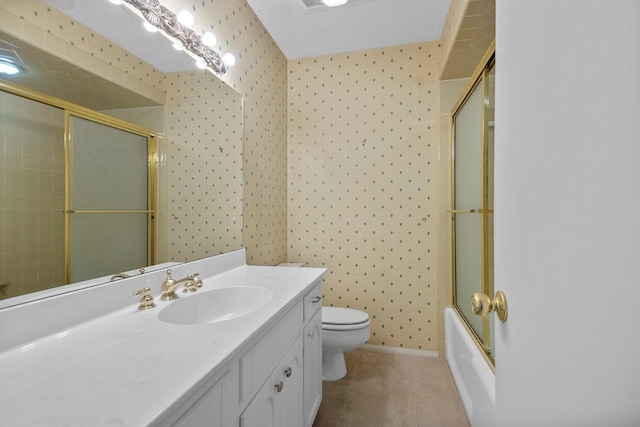 full bathroom with vanity, a textured ceiling, shower / bath combination with glass door, and toilet