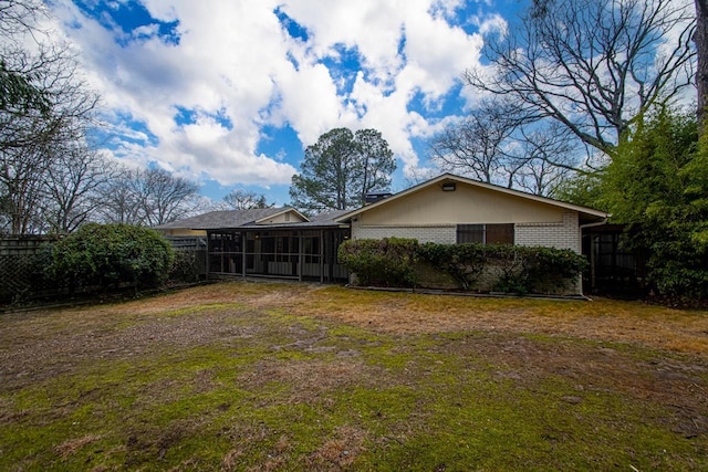 rear view of house featuring a sunroom