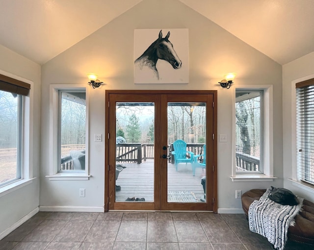 entryway with french doors, lofted ceiling, tile patterned flooring, and a wealth of natural light