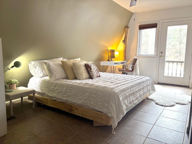 bedroom featuring access to exterior and vaulted ceiling