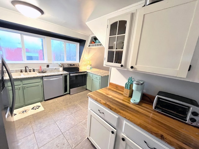 kitchen featuring appliances with stainless steel finishes, sink, green cabinets, and white cabinets