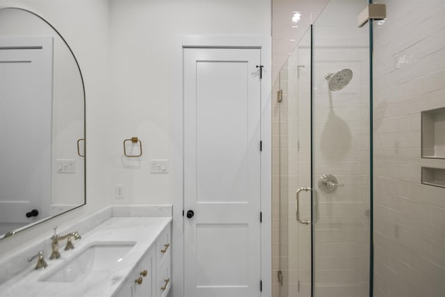 bathroom with a stall shower and vanity