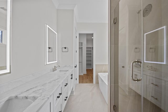 bathroom featuring shower with separate bathtub, vanity, and crown molding