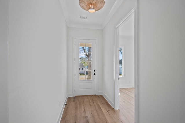 doorway to outside featuring light wood-type flooring, visible vents, and baseboards