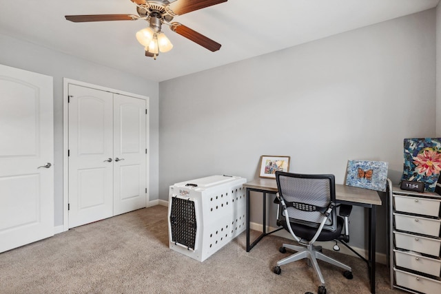 carpeted office featuring ceiling fan