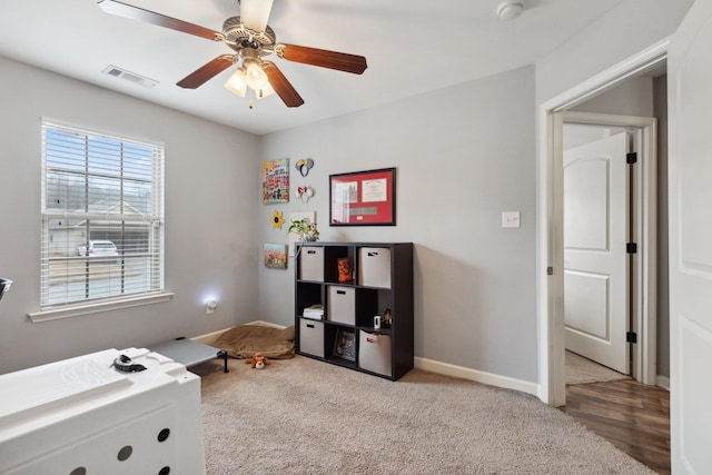 bedroom featuring ceiling fan and light carpet