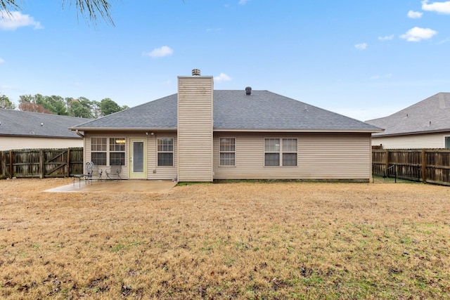 rear view of property featuring a patio area and a lawn