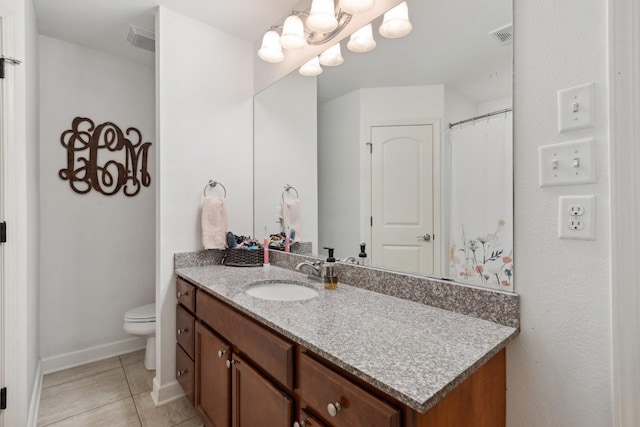 bathroom with tile patterned flooring, vanity, and toilet