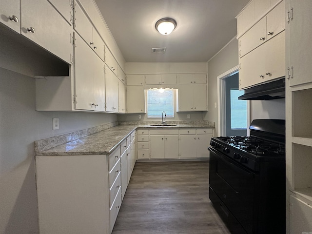 kitchen featuring white cabinetry, sink, dark wood-type flooring, and gas stove