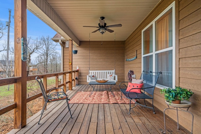 wooden terrace featuring ceiling fan