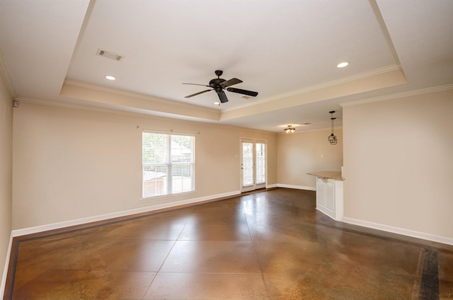 spare room featuring a tray ceiling, ornamental molding, and ceiling fan