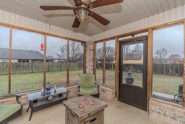 sunroom / solarium featuring ceiling fan