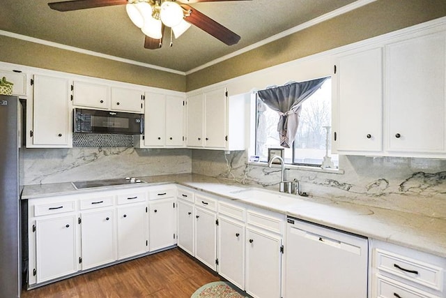 kitchen featuring white cabinets, ornamental molding, sink, and black appliances