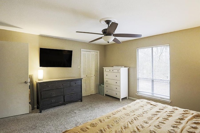 unfurnished bedroom featuring light carpet, a closet, and ceiling fan