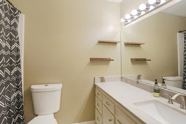 bathroom with vanity, toilet, and curtained shower