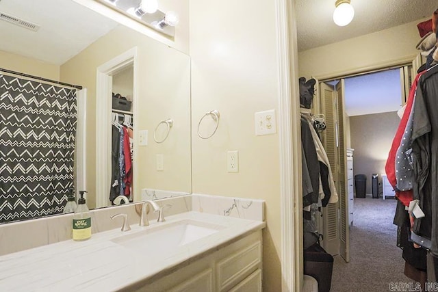 bathroom with vanity and curtained shower