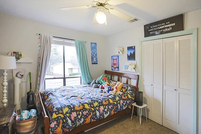 carpeted bedroom with ceiling fan and a closet