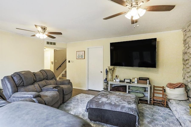 living room with ceiling fan and dark hardwood / wood-style flooring