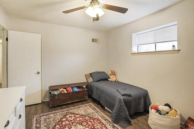 bedroom with ceiling fan and dark hardwood / wood-style flooring