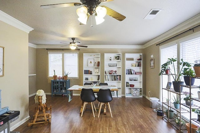 dining area featuring dark wood-type flooring, ornamental molding, and a textured ceiling