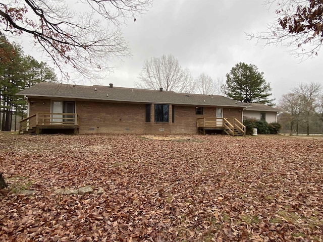 rear view of property with a wooden deck