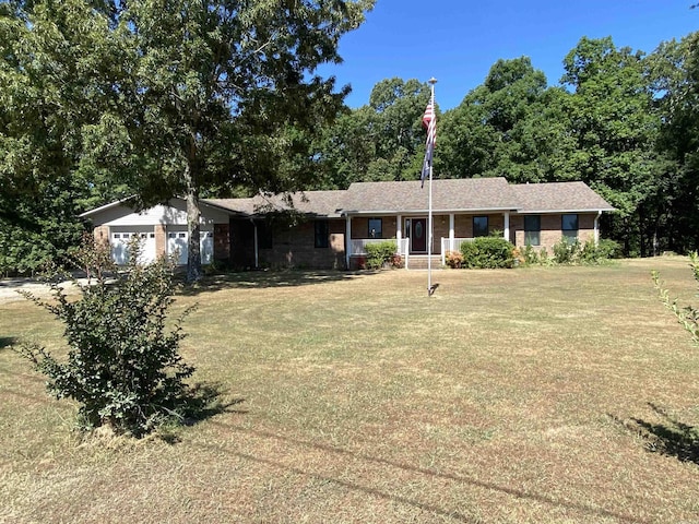 ranch-style house with a garage, covered porch, and a front lawn