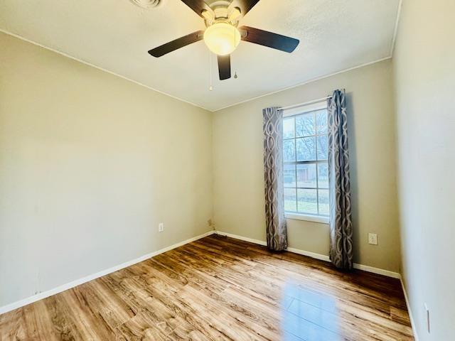 unfurnished room featuring hardwood / wood-style floors and ceiling fan