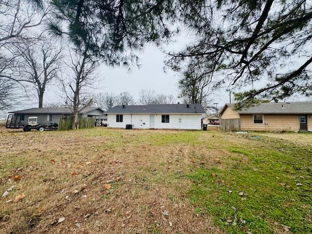 back of property featuring a lawn