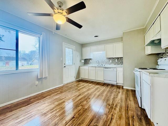 kitchen with tasteful backsplash, white cabinetry, light wood-type flooring, and white appliances