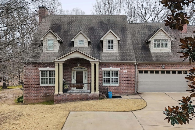 new england style home featuring a garage