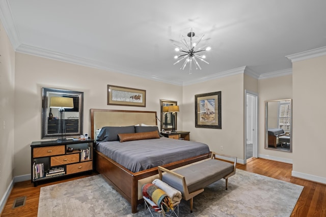 bedroom with a notable chandelier, crown molding, and wood-type flooring