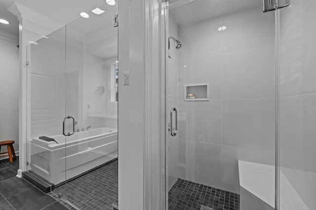 bathroom featuring tile patterned flooring and shower with separate bathtub