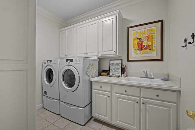 laundry area featuring sink, washer and clothes dryer, cabinets, ornamental molding, and light tile patterned flooring