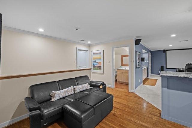 living room featuring crown molding and light wood-type flooring