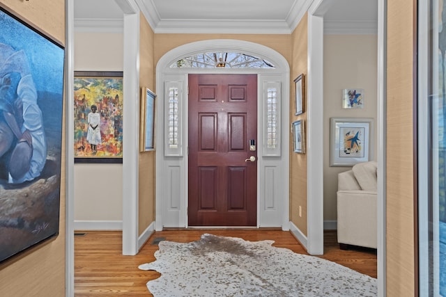 entrance foyer with crown molding and light hardwood / wood-style flooring