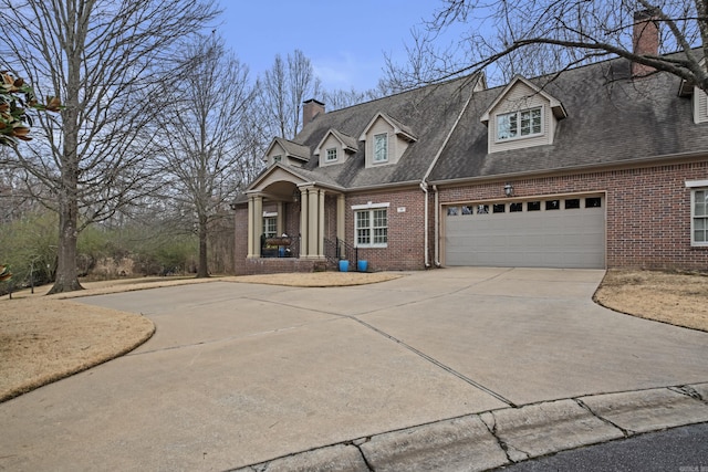 cape cod home featuring a garage