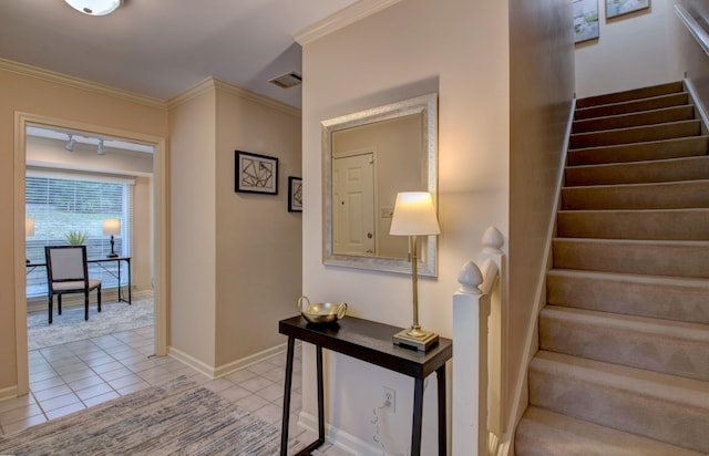 stairs with ornamental molding and tile patterned floors