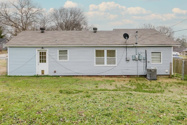 rear view of house with a yard and central AC