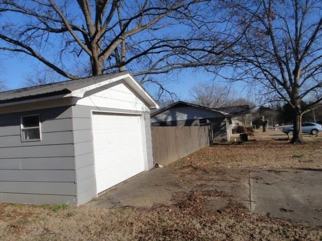 view of side of home featuring a garage and an outdoor structure