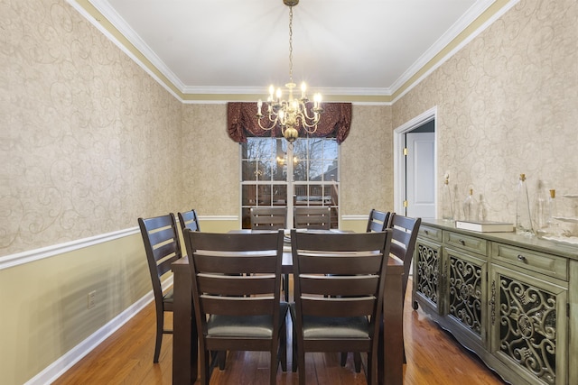 dining area featuring ornamental molding, dark hardwood / wood-style flooring, and a chandelier