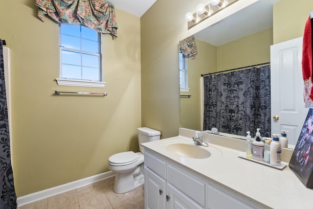 bathroom with vanity, a healthy amount of sunlight, tile patterned floors, and toilet