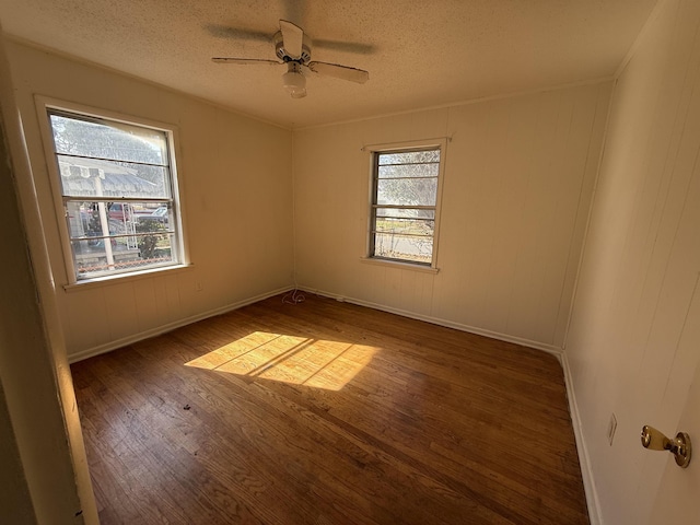 unfurnished room featuring a textured ceiling, dark hardwood / wood-style floors, and ceiling fan