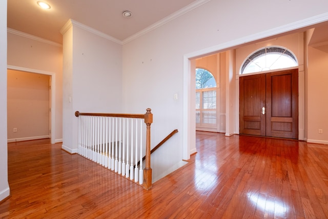 foyer entrance with hardwood / wood-style flooring and ornamental molding