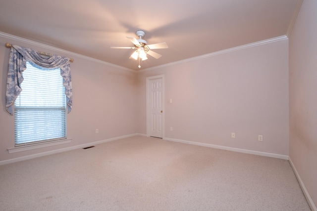 carpeted spare room featuring ornamental molding and ceiling fan