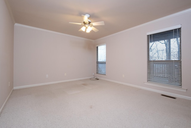 spare room featuring crown molding, carpet flooring, and ceiling fan