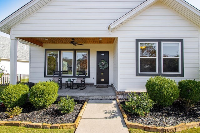 entrance to property featuring ceiling fan and covered porch