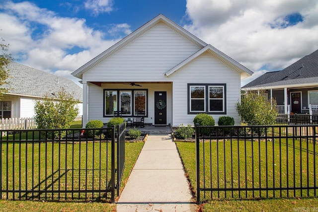 bungalow-style house with covered porch and a front lawn