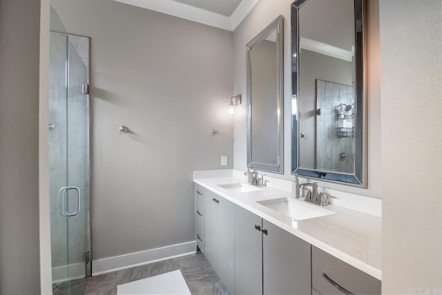 bathroom with vanity, crown molding, and walk in shower