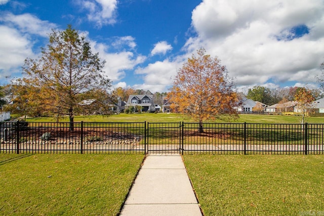 view of property's community featuring a yard