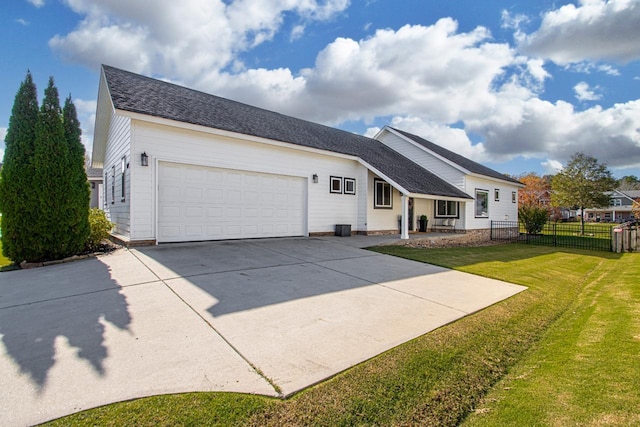 view of front of home featuring a garage and a front lawn